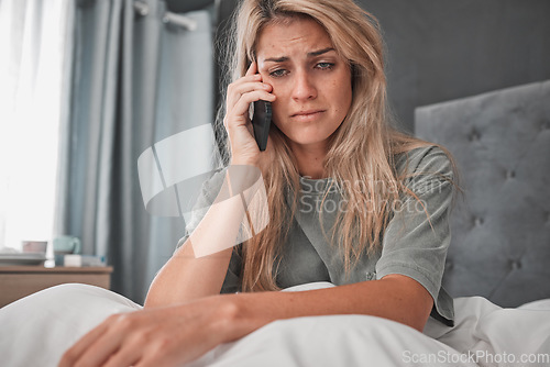 Image of Sad, stress and woman with depression in a phone call conversation in her bedroom worried about a break up. Mental health, anxiety and depressed girl disappointed after listening to bad news at home