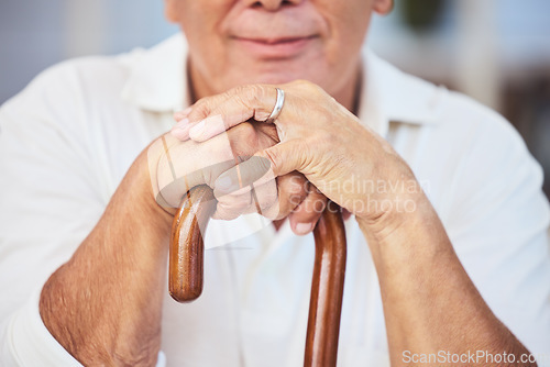 Image of Old man hands, walking stick and disability from osteoporosis, arthritis and aging. Closeup of lonely, retirement and disabled senior widower with dementia, pain and wooden cane for support