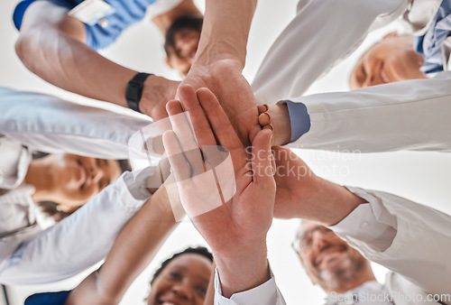 Image of Hands, doctor and teamwork below in hospital for motivation, inspiration and diversity at work. Medical, team and hand together in collaboration at clinic, help community in healthcare and wellness