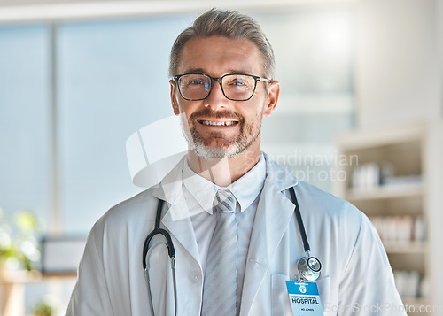 Image of Doctor, smile and office working at hospital, clinic or medical facility. Medic, man and happy at work with stethoscope, glasses and happiness on face in portrait at healthcare center in Atlanta