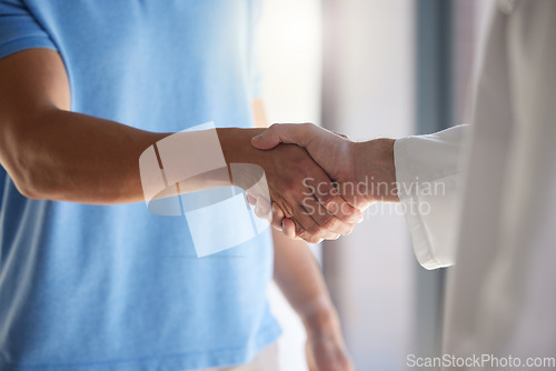 Image of Handshake, trust and respect with a patient and medical worker or doctor shaking hands, greeting or introduction during consultation. Closeup of men with thank you gesture or welcome, agree or greet