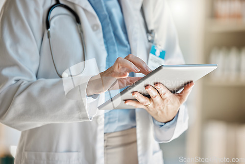 Image of Doctor, office and tablet for research, email or communication. Medic, hospital and reading article, data or health magazine on web, while working with technology in healthcare center or clinic