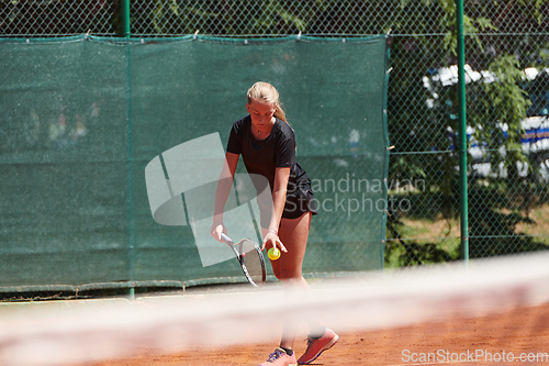 Image of A young girl showing professional tennis skills in a competitive match on a sunny day, surrounded by the modern aesthetics of a tennis court.