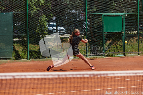 Image of A young girl showing professional tennis skills in a competitive match on a sunny day, surrounded by the modern aesthetics of a tennis court.