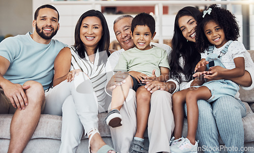 Image of Family, sofa and happy in living room in portrait together in home or on vacation. Children, parents and grandparents love, happiness and smile while on holiday, in hotel or house in Houston, Texas