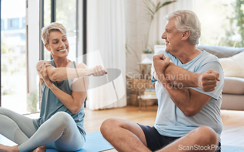 Image of Stretching, home fitness and senior couple training together on the living room floor in the house. Happy elderly man and woman doing yoga, pilates exercise and cardio for body health in the lounge