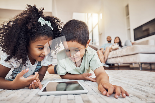 Image of Streaming video, internet tablet and children watching cartoon on technology on the living room floor. Sibling kids learning on the internet with tech and relax with movie online together in house