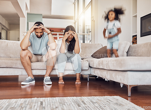 Image of Tired parents, frustrated and active child being naughty and playful, adhd daughter playing by upset, stressed and depressed mother and father at home. Energy of girl kid jumping by man and woman