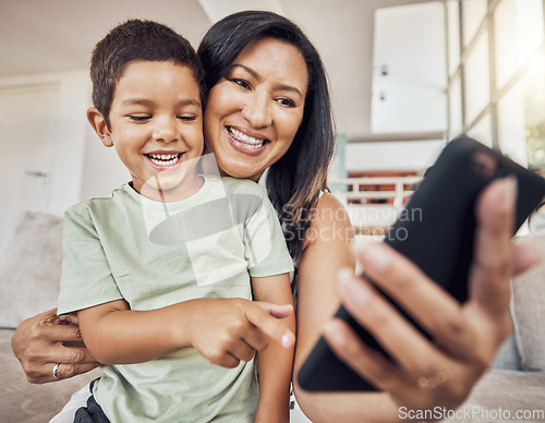 Image of Happy mother and child with smartphone on sofa for games app, funny social media post or elearning website. Kid with mom on couch and cellphone education, video call or watch comedy video online