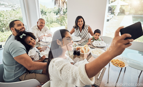 Image of Big family, phone selfie and food in home, eating and spending time together on table. Generations, grandfather and parents with kids smiling sharing lunch picture post on social media on 5g mobile.