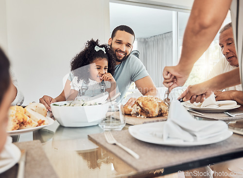 Image of Family lunch in dining room, happy father with young girl child and woman cutting roast chicken in Atlanta. Hungry daughter eating supper at dinner table, smile together on weekend and home food