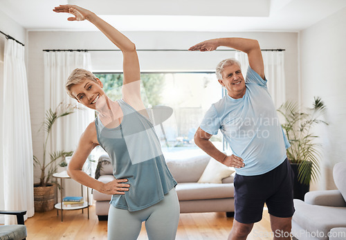 Image of Stretching, yoga and fitness with a senior couple doing an exercise, workout or training at home. Health and wellness, lifestyle and active with a fit elderly man and woman exercising in a house