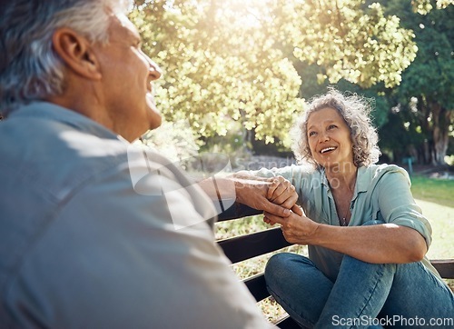 Image of Elderly, couple and happy on bench in garden for conversation, bonding and happiness by trees in summer. Man, woman and retirement show love, relax and smile together in nature with sunshine at park