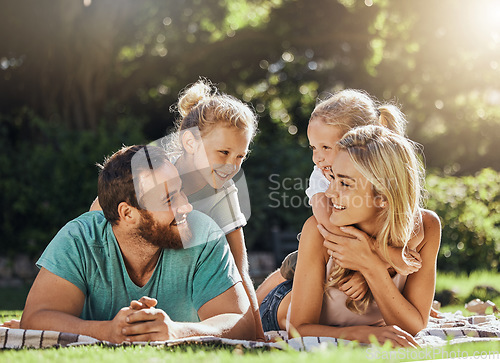 Image of Picnic park and family with children relax on grass together for outdoor bonding, love and care with sunshine summer lens flare and trees. Nature, healthy and support parents with girl kids on ground