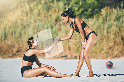 Image of Volleyball teamwork, women support on beach sports in Brazil summer fitness and help in healthy lifestyle. Young athletes shake hands, friends training together in bikini and helping motivate girl