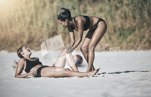 Image of Sports, beach volleyball and woman knee injury, outdoors or in nature. Health, fitness and female with fracture, pain or broken bone on sandy field and friend girl helping after exercise or workout.