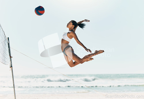 Image of Sports woman jump at volleyball beach summer outdoor competition game on ocean or sea sand playing to win. Healthy, fitness and training agile girl or young athlete ready hit ball over net in match