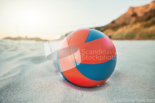 Image of Beach, ball and volleyball on sand, a game at sunset at tropical ocean destination. Fitness, fun and summer sports at the sea in the evening. White sandy coast, a volley ball and an empty seascape.