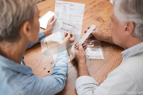 Image of Old couple, documents and pcr covid test, health and testing for corona virus diagnosis at home. Covid 19, healthcare and senior, retired man and woman with medical kit for self screening in pandemic