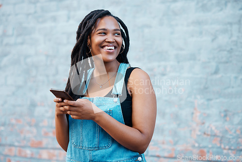 Image of Smartphone, digital networking and black woman with mobile app, social media post or 5g internet outdoor with mock up blue wall. Happy african gen z girl typing on her cellphone for youth online blog