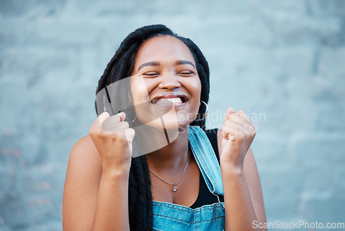 Image of Black woman, happy and excited smile of a winner from Jamaica feeling happiness. Smiling face of a person with excitement, positive energy and gratitude mindset with a gray brick background