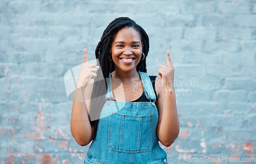 Image of Mockup portrait of happy black woman pointing for marketing, advertising or news announcement. Happiness, smile and young gen z student girl with mock up hands sign isolated on blue background wall