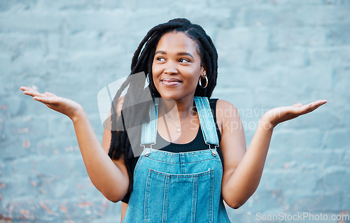 Image of Model, smile and hands for gesture of confusion pose in street against blue wall. Black woman, question and confused sign in city against urban background with dreadlocks in Cape Town, South Africa