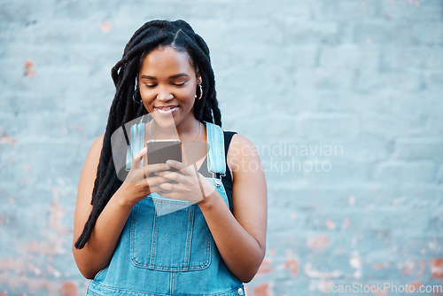 Image of Happy black woman typing on smartphone on social media marketing, advertising or mobile app on blue wall background mockup. Gen z teenager with cellphone networking, online chat or check notification