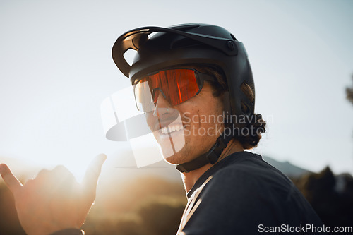 Image of Mountain bike, nature and man cycling for fitness training in the mountains of Peru during summer. Portrait of a sports person with glasses during adventure in the countryside and hands sign
