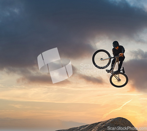 Image of Mountain bike, jump and sport with mockup of a man athlete with energy and speed in nature. Healthy sports person with speed jumping and cycling with his bicycle at sunset on mountains with mock up