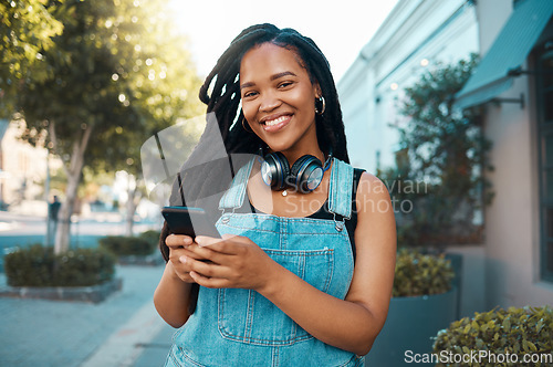 Image of Happy black woman in the city, in conversation on smartphone and texting on social media. Walking the street, urban black girl smiling and using 5g connection for mobile communication with happiness