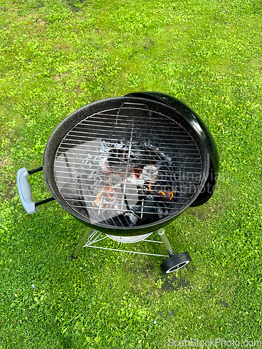 Image of open charcoal grill