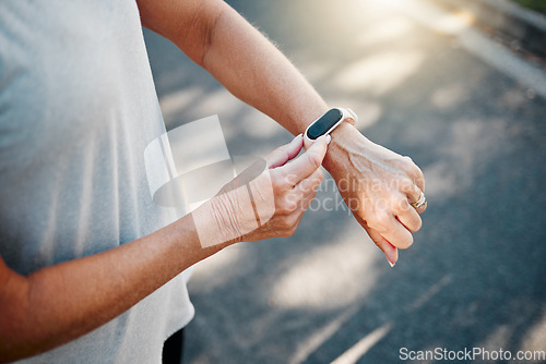 Image of Senior woman, fitness runner with smartwatch for results, health and wellness on road exercise, training or run workout. Watch, running elderly athlete and street, city or check for marathon time