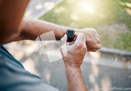 Image of Man, street and running with smartwatch for heart reading, health and fitness on break. Runner, watch and road check time, speed or distance on workout, exercise or training outside for body wellness