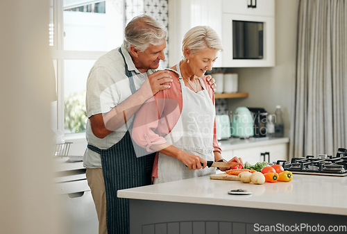 Image of Senior couple, bonding and cooking in kitchen in a house or home for marriage anniversary or celebration lunch. Smile, happy and love retirement elderly man and woman with nutrition health food