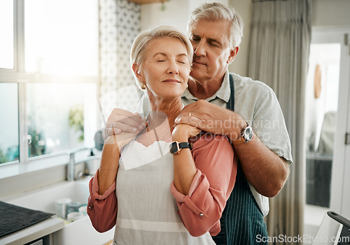 Image of Senior, couple and love in kitchen for embrace together in romance, care and bonding in home. Elderly man, woman and retirement show happiness, relax and happy look on face in house in Houston, Texas