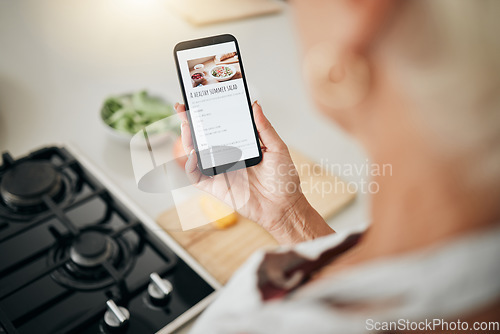 Image of Recipe, cooking and healthy food list on a phone screen with a woman to cook in a kitchen home. Nutritionist person ready to start health, nutrition and vegetables for a meal using mobile technology