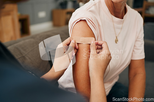 Image of Covid, vaccine and plaster with a doctor and patient consulting during a home visit, appointment or checkup. Nurse, healthcare and insurance with a woman in her house during the corona virus pandemic