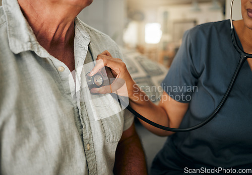 Image of Doctor, hand and stethoscope of senior care in heart rate check, appointment or cardiology at home. Hands of nurse or healthcare professional checking elderly patient pulse on chest for medical test