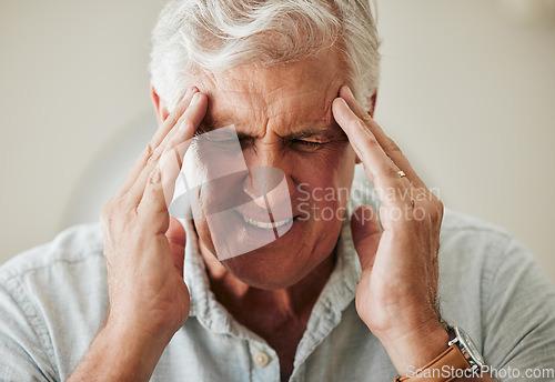 Image of Senior man, suffering with headache pain from stress and painful head migraine. Elderly people at risk for mental health problems like anxiety and depression or loneliness from old age in retirement