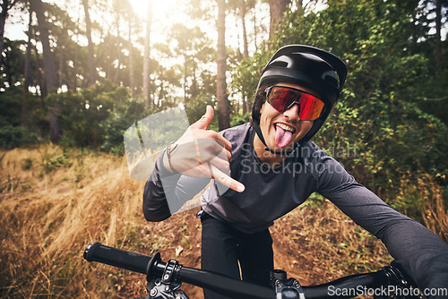 Image of Mountain bike, cycling and fitness with a man gesture a shaka hand sign while training or exercise in Brazil nature. Portrait of a professional male sports athlete doing cardio ednurance in a forest