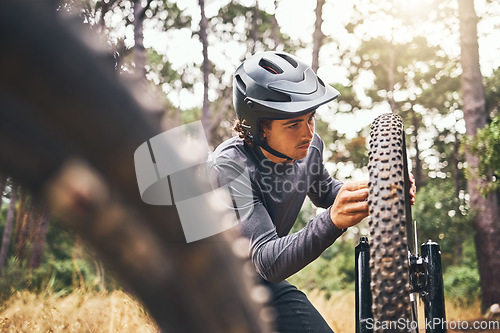 Image of Cycling, adventure trail and bike repair, man fix wheel in forest. Nature, mountain biking and cyclist, outdoor cycle maintenance in Australia. Bicycle ride, dirt path and biker stop for tyre change.