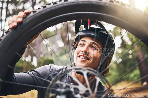 Image of Bicycle, cycling and man check tire quality, pressure or stability for nature travel, exercise or fitness training. Mountain bike sports person checking wheel for health workout in Canada forest park