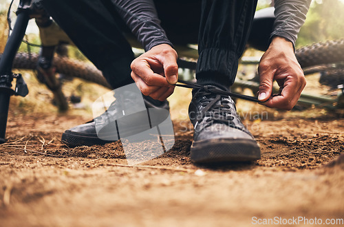 Image of Man outdoor shoes, ready for exercise training with bike and travel sports. Cardio adventure on mountain bicycle trail, cyclist prepare for start of fitness and closeup cyclist tie shoelace on ground