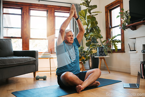 Image of Yoga, meditation and wellness with a zen man following an online class for fitness, exercise and workout at home. Senior, retirement and health with an elderly male pensioner exercising in his house