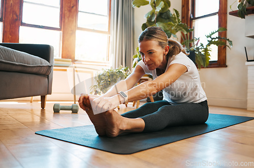 Image of Senior woman, stretching and exercise in living room for fitness, cardio and wellness on yoga mat home training. Retirement, workout and healthy elderly retired person exercising legs on house floor