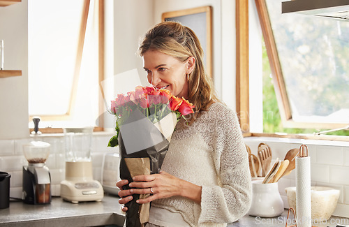 Image of Flowers, smile, and elderly woman smelling rose in a kitchen, surprised by sweet gesture and or secret gift. Happy, romantic and kind surprise for mature, excited woman on valentines morning