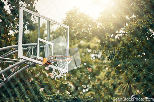 Image of Nature, basketball court and basket for fitness training and game tournament score exercise. Outdoor sports venue net for competition goal practice and cardio workout with sunshine flare.