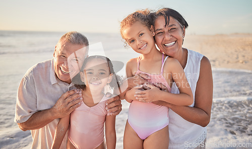 Image of Family, children and beach with a girl, grandparents and sister on the sand by the ocean or sea at sunset. Kids, summer and travel with a grandfather, grandmother and grandchildren on holiday