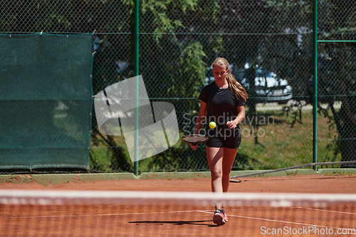 Image of A young girl showing professional tennis skills in a competitive match on a sunny day, surrounded by the modern aesthetics of a tennis court.